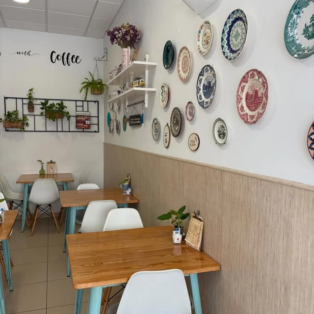 Interior da cafetaria com pratos decorativos na parede